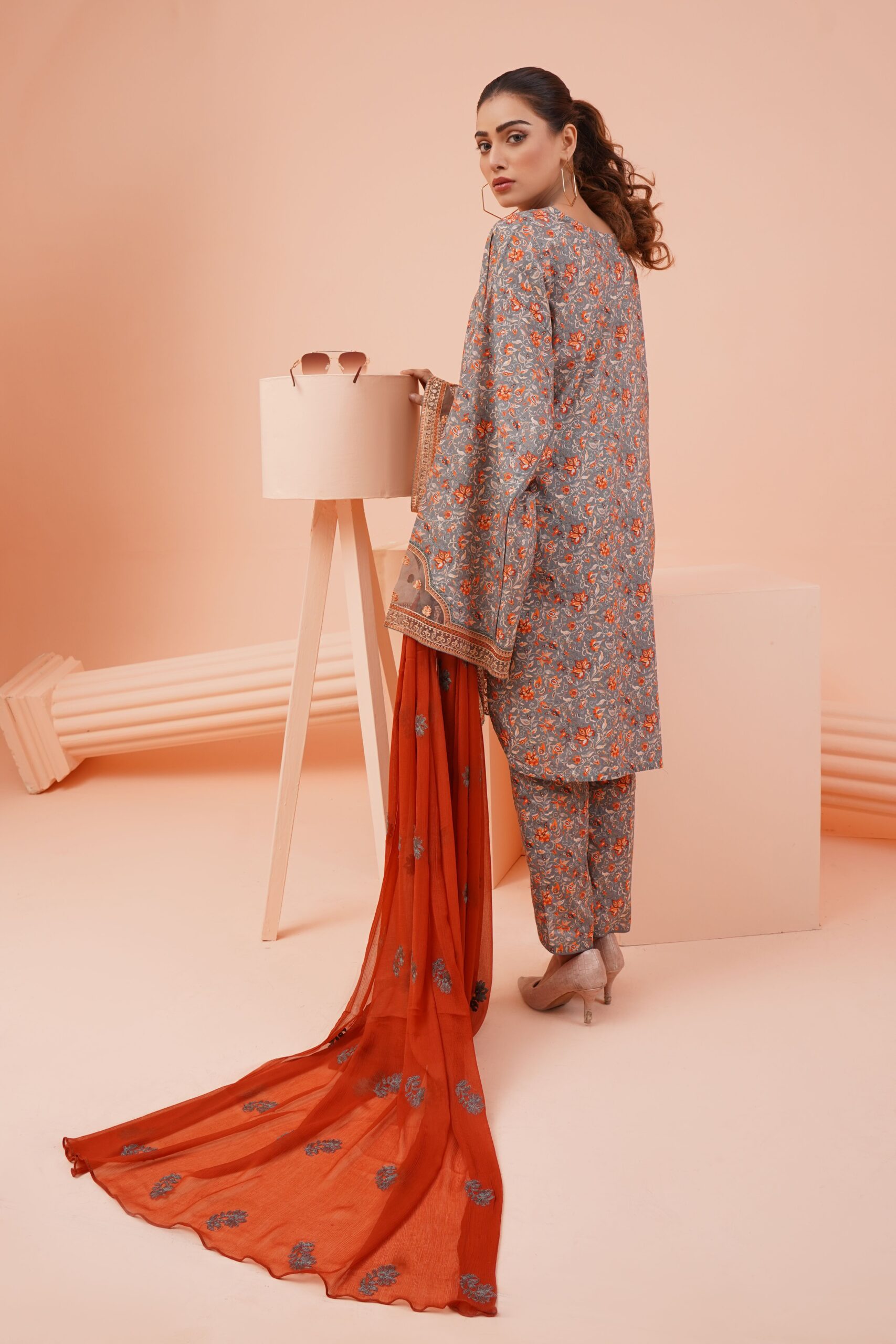 Elegant South Asian woman in traditional attire posing in a studio setting.